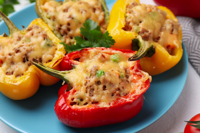 Photo of Tasty stuffed bell peppers on table, closeup