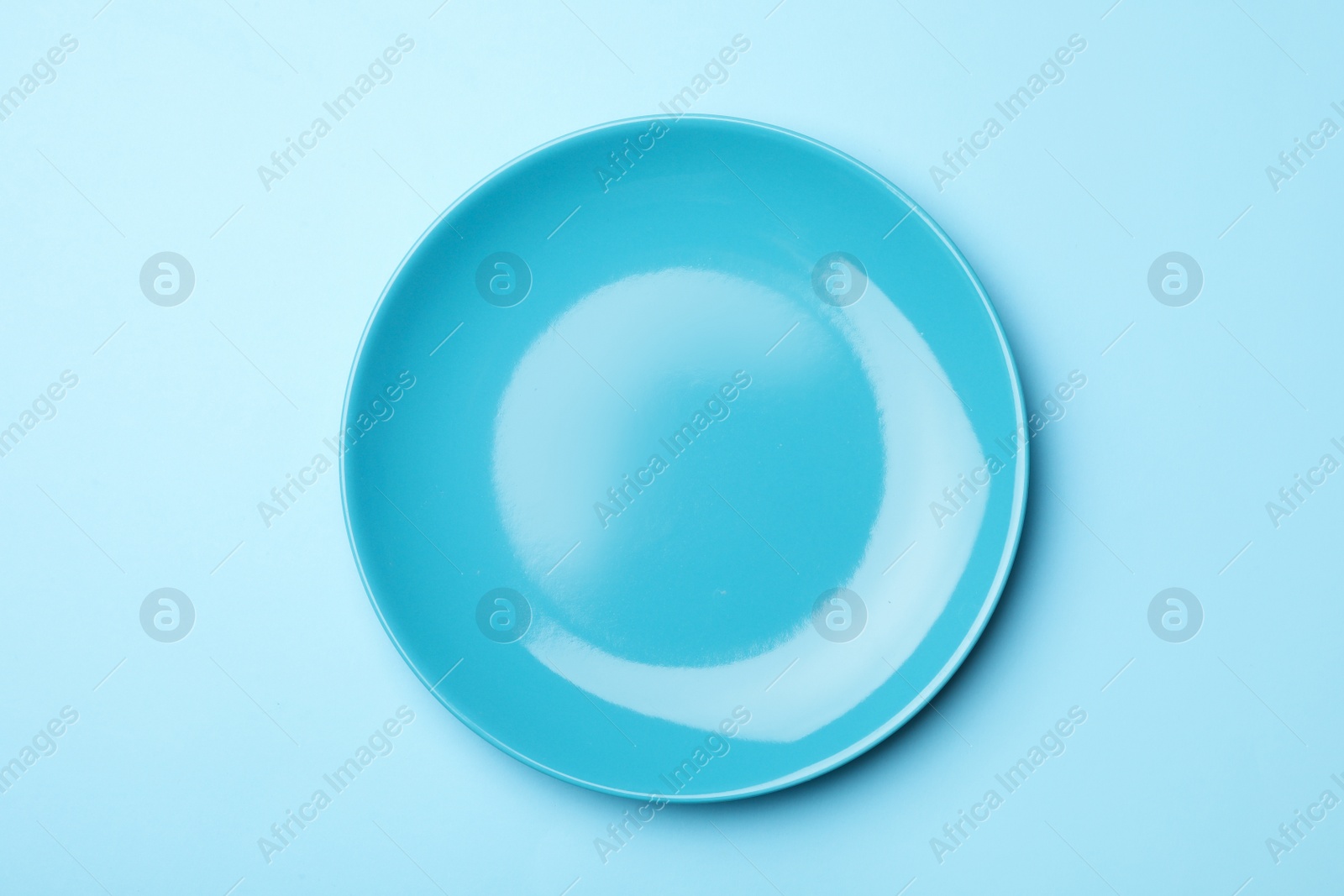 Photo of Stylish ceramic plate on color background, top view