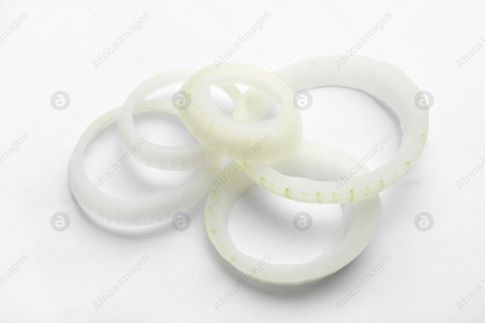 Photo of Fresh raw onion rings on white background