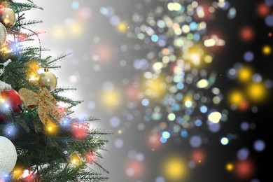 Image of Beautiful Christmas tree with bright baubles against blurred lights on dark background, closeup. Space for text