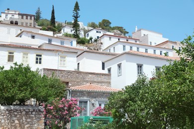 Photo of City street with beautiful buildings and plants on sunny day