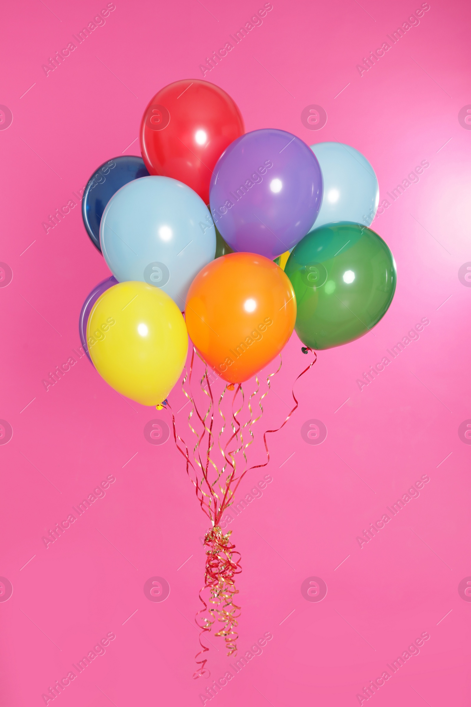 Photo of Bunch of bright balloons on color background