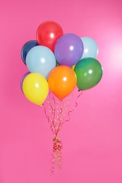 Bunch of bright balloons on color background