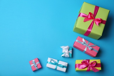 Photo of Flat lay composition with gift boxes on color background