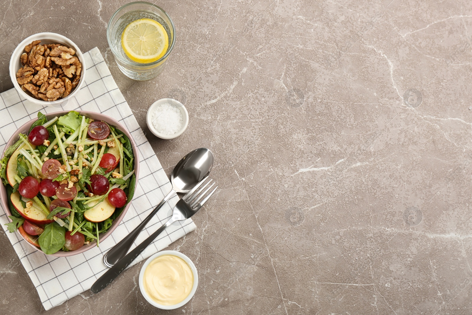 Photo of Delicious fresh celery salad served on grey table, flat lay. Space for text