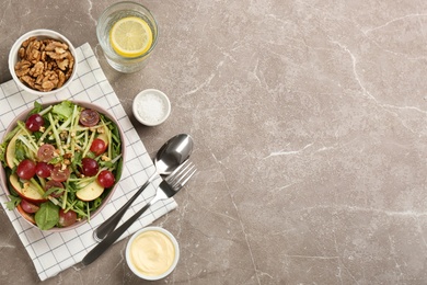 Photo of Delicious fresh celery salad served on grey table, flat lay. Space for text