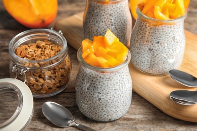 Photo of Tasty chia seed pudding with persimmon served on table