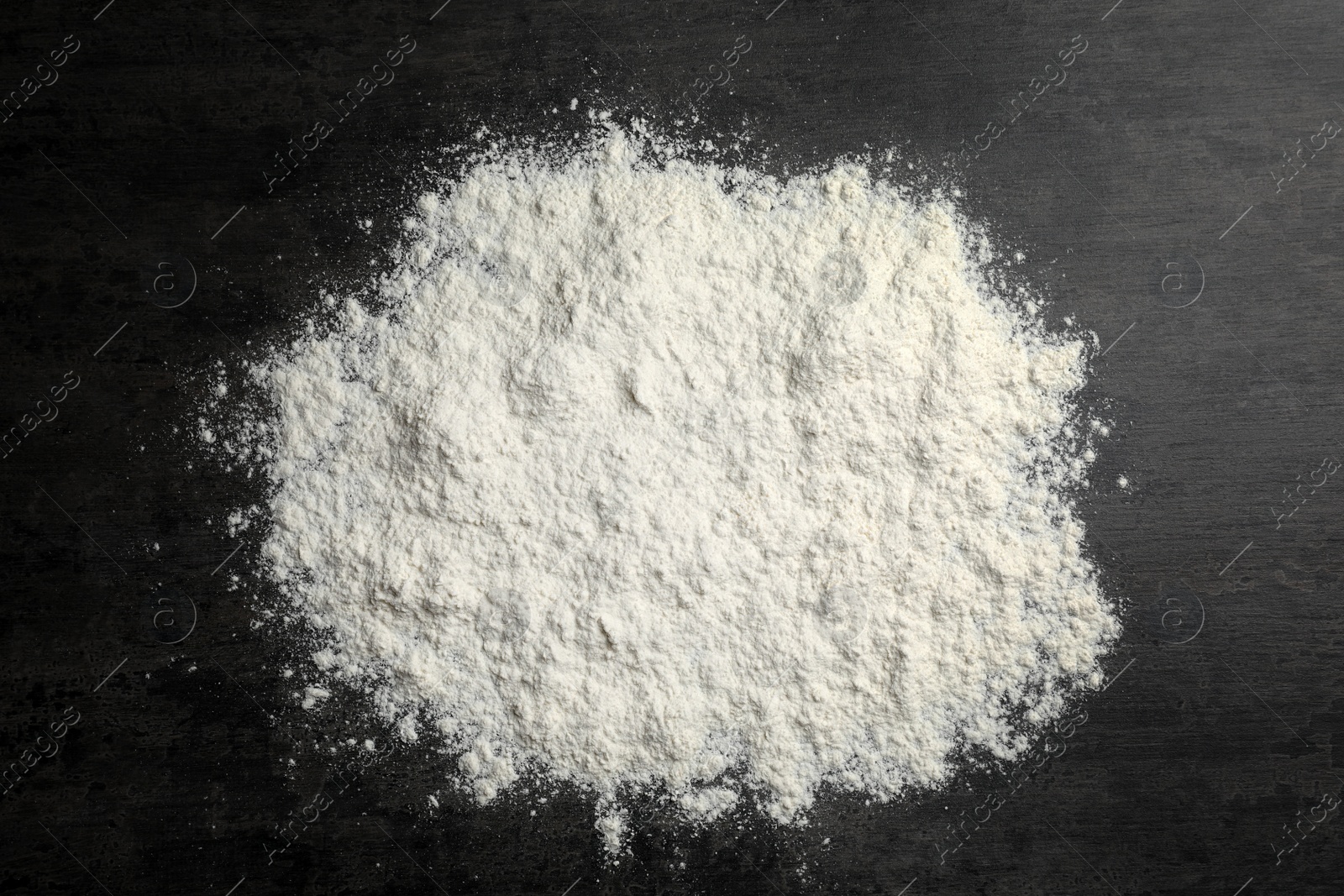 Photo of Scattered wheat flour on gray background, top view