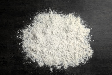 Photo of Scattered wheat flour on gray background, top view