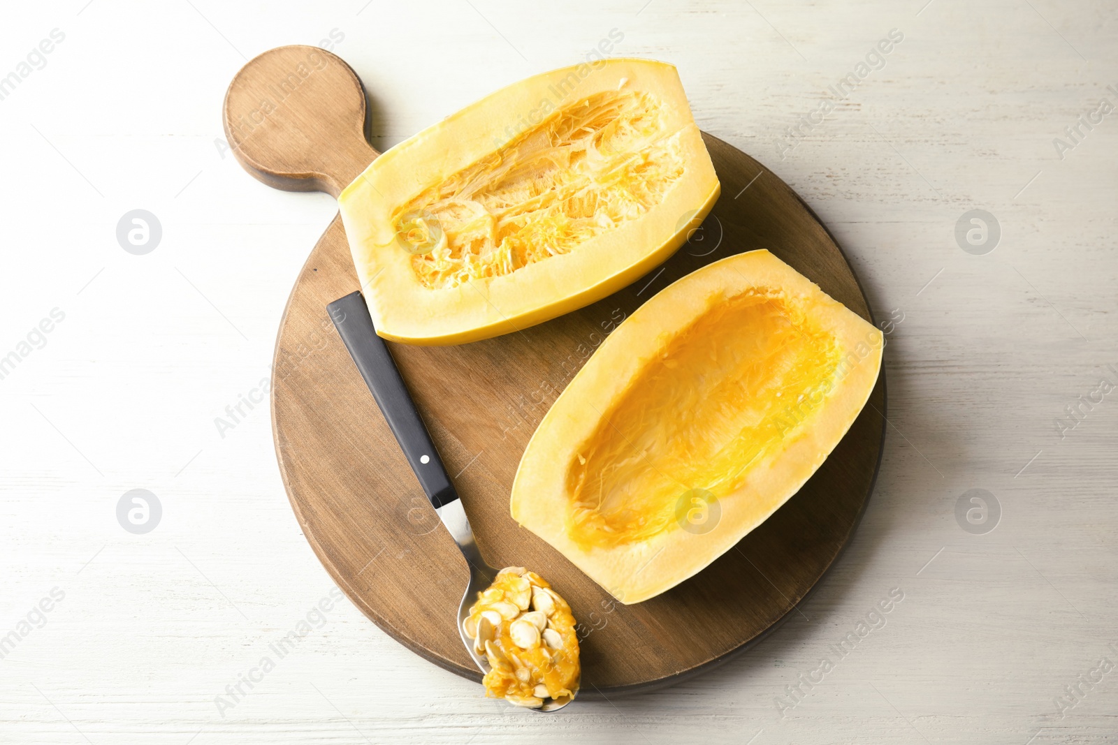 Photo of Cut spaghetti squash on wooden table, top view