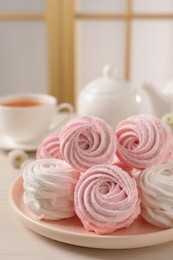 Plate with delicious marshmallows on table, closeup