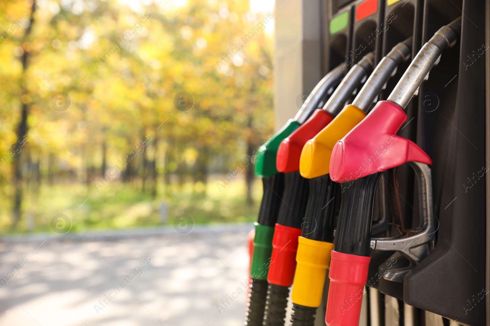 Photo of Petrol pump filling nozzles at gas station