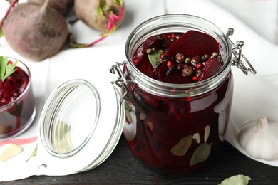 Pickled beets in glass jar on table