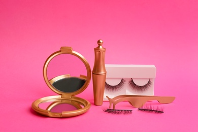 Photo of Magnetic eyelashes and accessories on crimson background