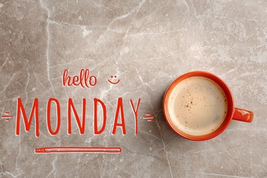 Image of Cup of hot aromatic coffee and phrase Hello Monday on marble background, top view
