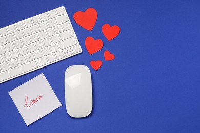 Photo of Long-distance relationship concept. Computer mouse, keyboard, love note and paper hearts on blue background, flat lay with space for text