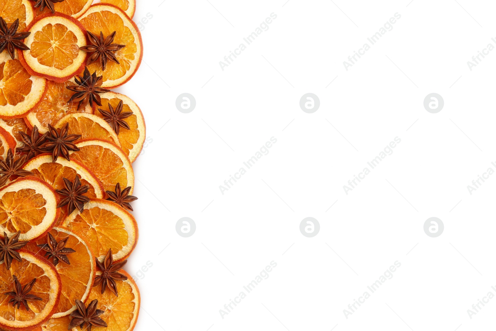 Photo of Dry orange slices and anise stars on white background, flat lay. Space for text