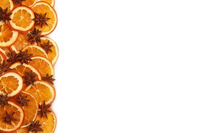 Photo of Dry orange slices and anise stars on white background, flat lay. Space for text