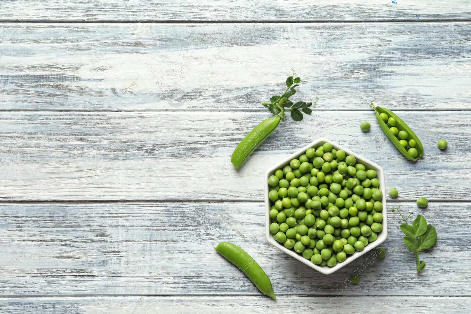 Photo of Flat lay composition with green peas on wooden background