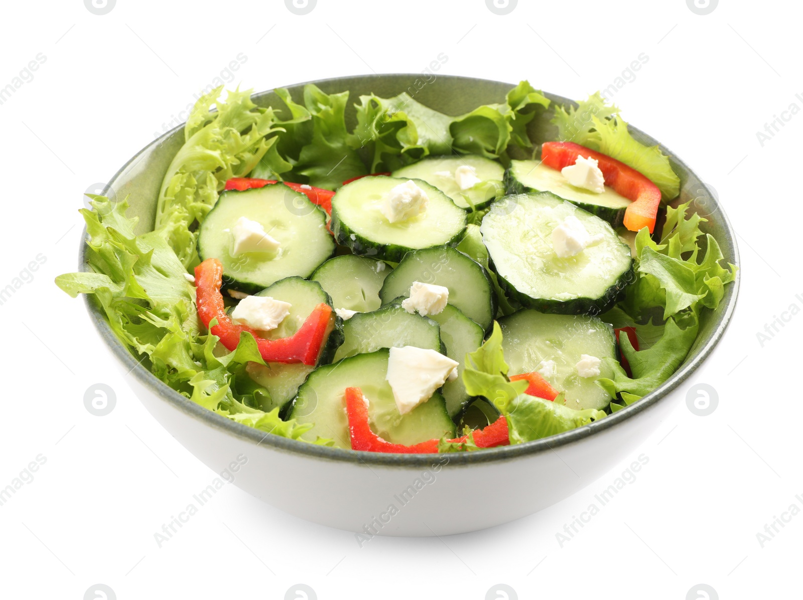 Photo of Delicious salad with cucumbers, red bell pepper and feta cheese in bowl isolated on white