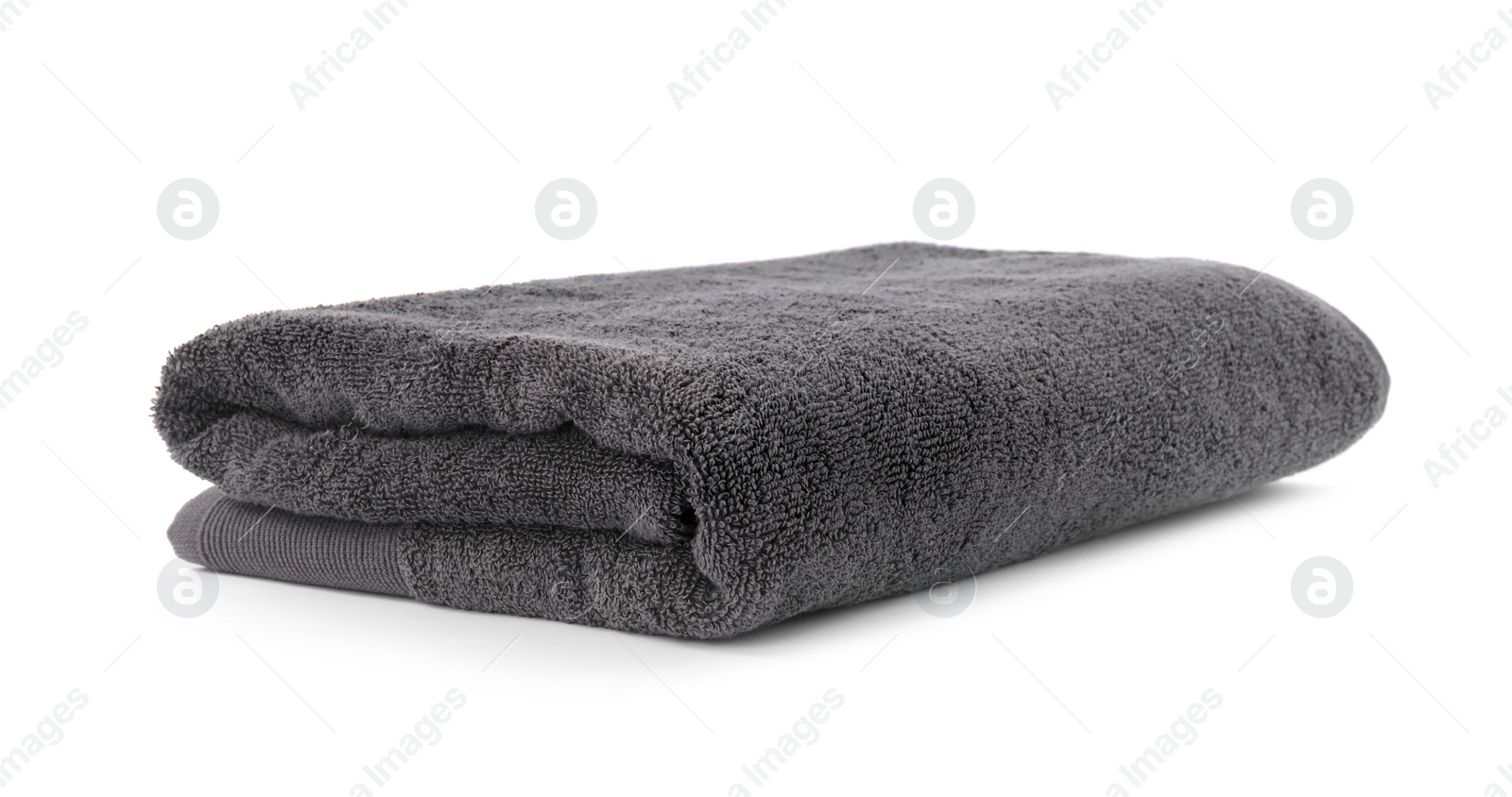 Photo of Folded soft terry towel isolated on white