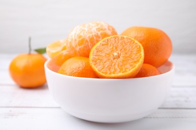 Photo of Fresh juicy tangerines on white wooden table, closeup