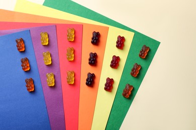 Delicious gummy bear candies on color background, flat lay