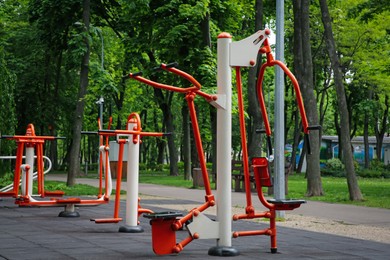 Empty outdoor gym with chest press machine, ovate stepper, twister and surfer