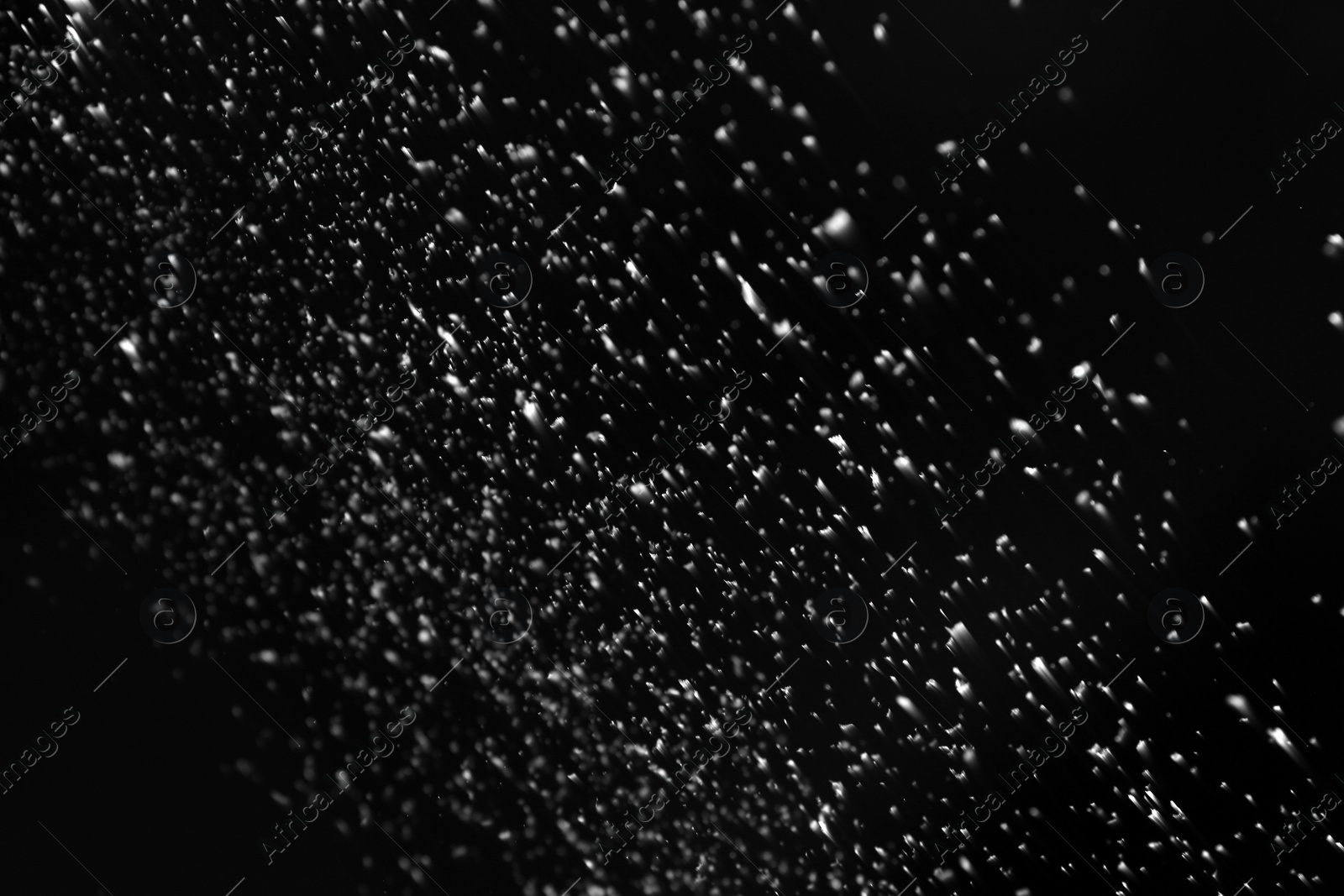 Photo of Snow flakes falling on black background. Winter weather