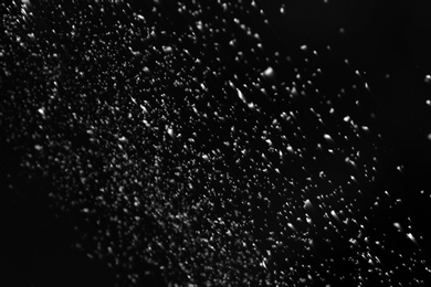 Snow flakes falling on black background. Winter weather