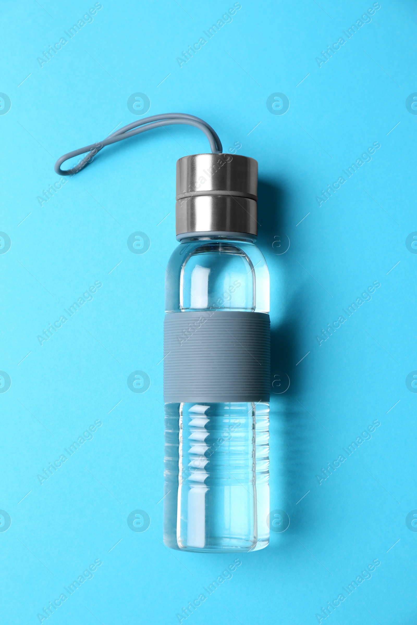 Photo of Sport bottle with water on color background