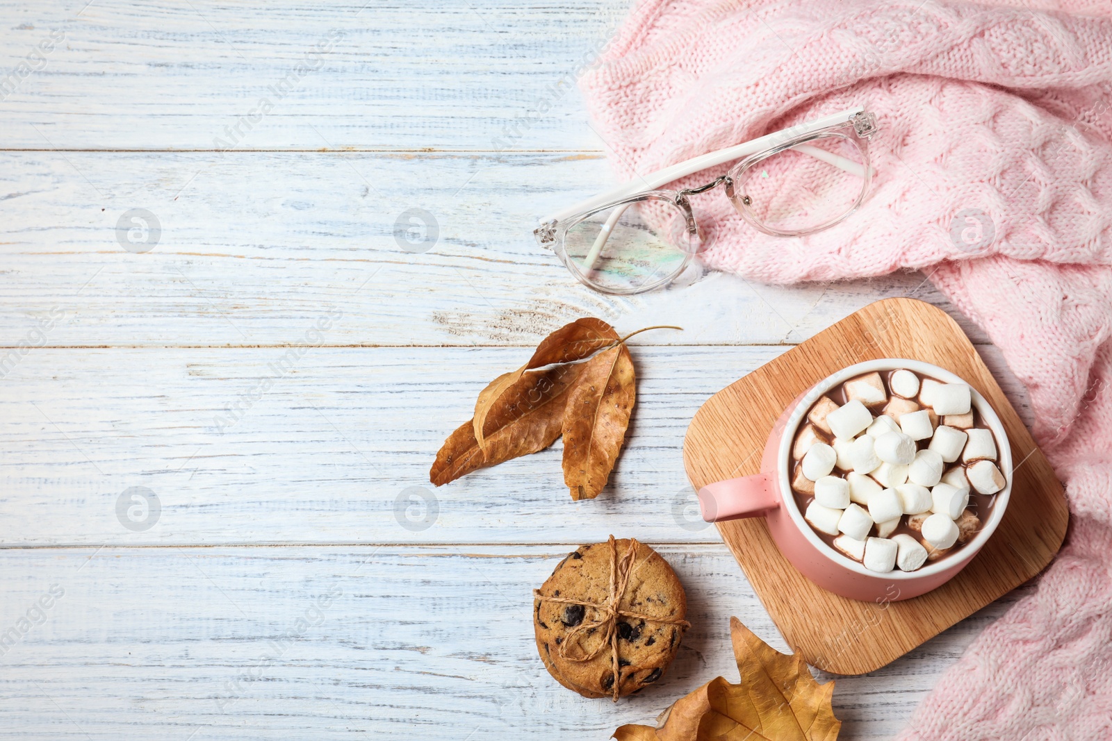 Photo of Flat lay composition with cup of hot drink on white wooden table, space for text. Cozy autumn atmosphere
