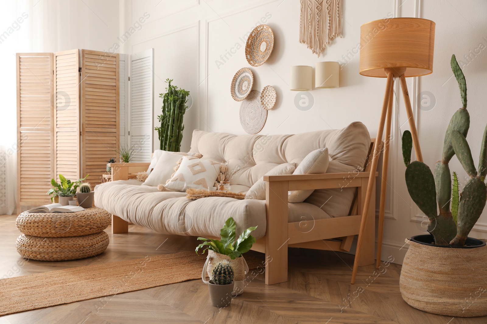 Photo of Stylish living room interior with comfortable wooden sofa and beautiful houseplants