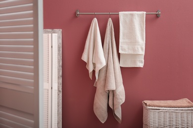 Photo of Bathroom interior with laundry basket and soft towels