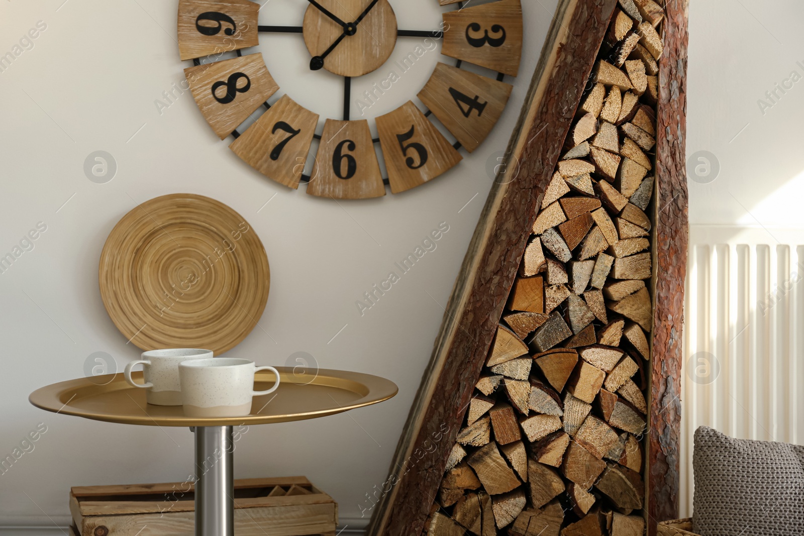 Photo of Firewood as decorative element in stylish room interior