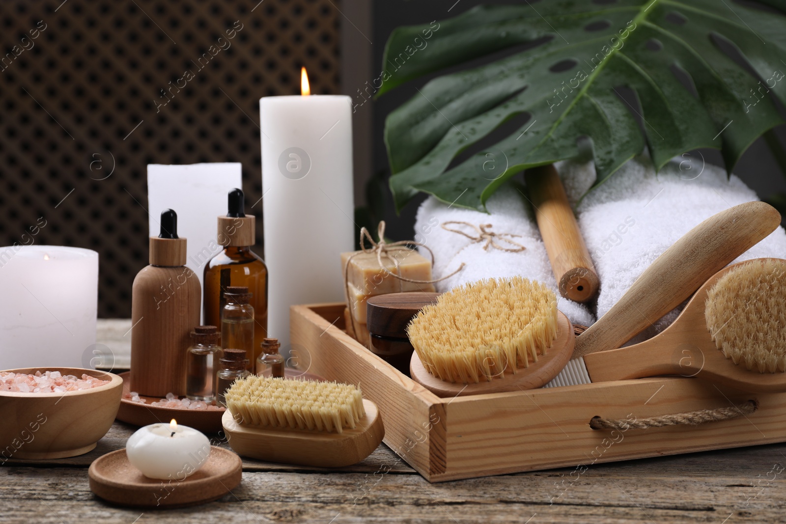 Photo of Composition with different spa products and burning candles on wooden table