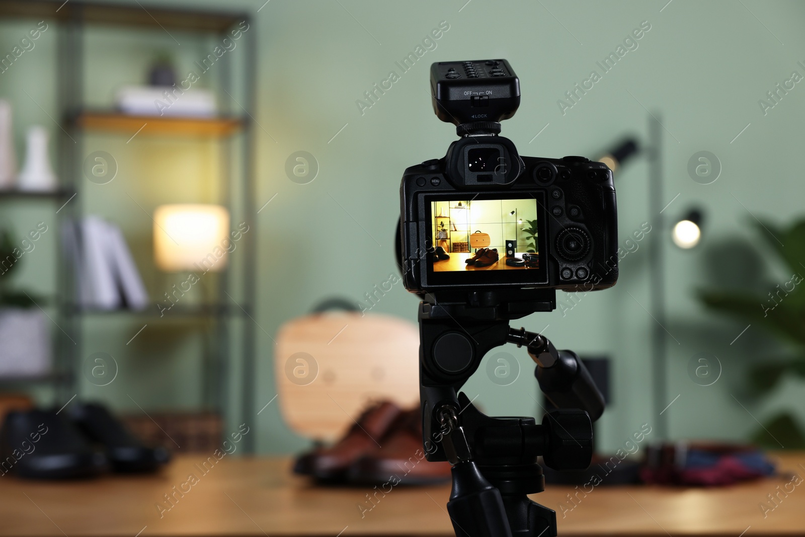 Photo of Beauty blogger's workplace. Men's accessories on table indoors, focus on camera