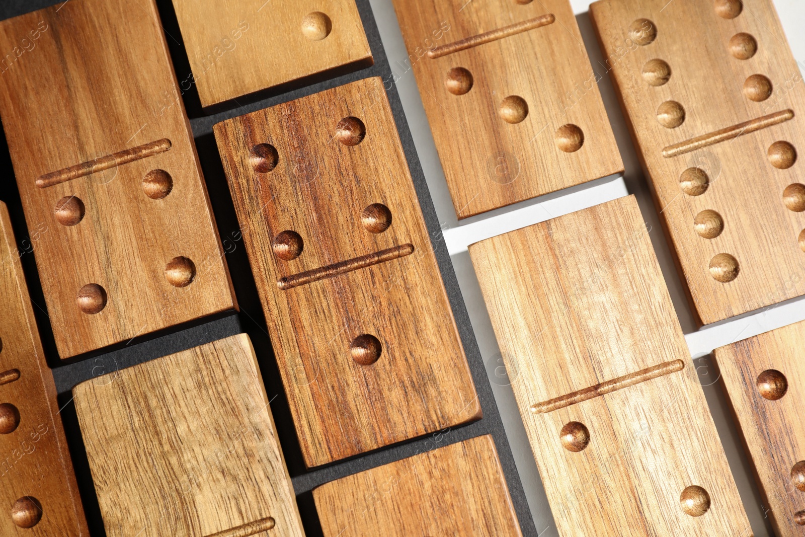 Photo of Set of wooden domino tiles on color background, flat lay