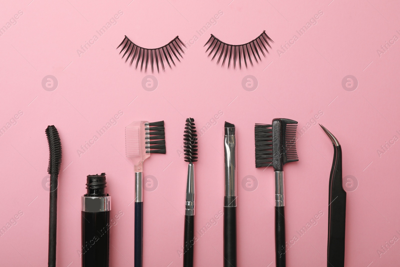 Photo of Flat lay composition of professional makeup tools and false eyelashes on color background