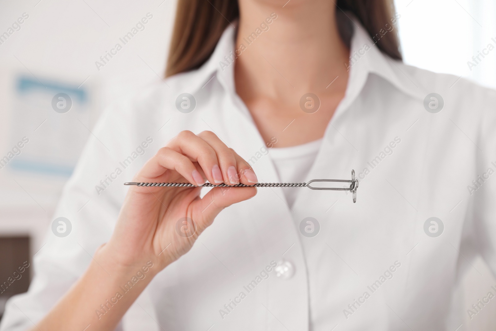 Photo of Speech therapist with logopedic probe in clinic, closeup