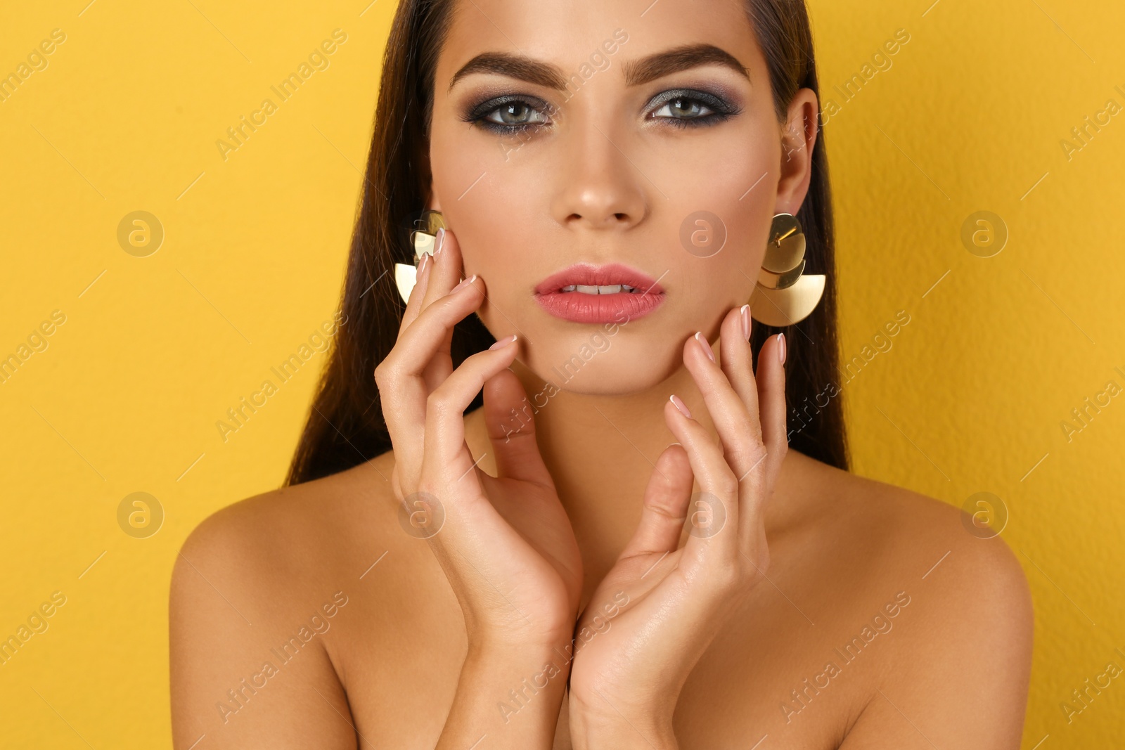 Photo of Portrait of beautiful woman with stylish makeup on color background