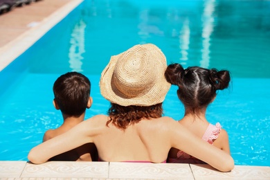 Woman with children in swimming pool at resort