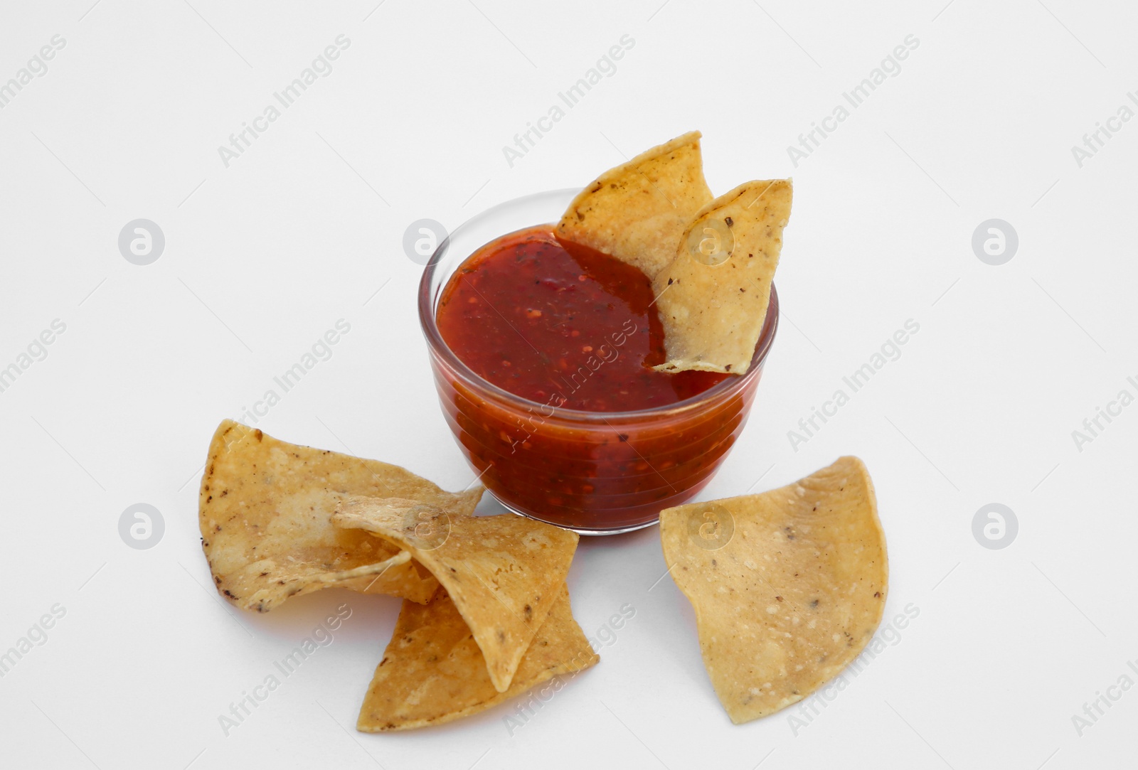 Photo of Tasty salsa sauce and tortilla chips on white background