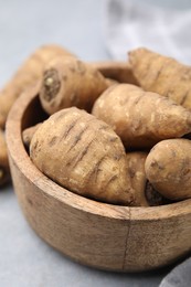 Tubers of turnip rooted chervil on light grey table, closeup