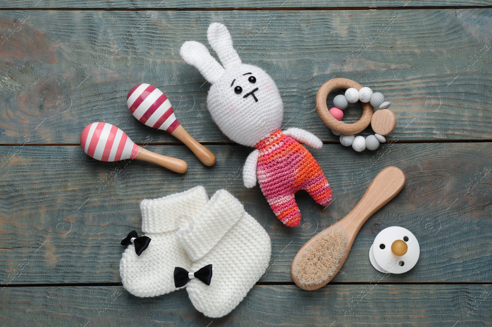 Photo of Cute baby stuff on light blue wooden background, flat lay