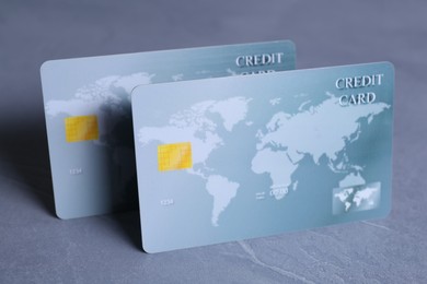 Photo of Two credit cards on grey textured table, closeup