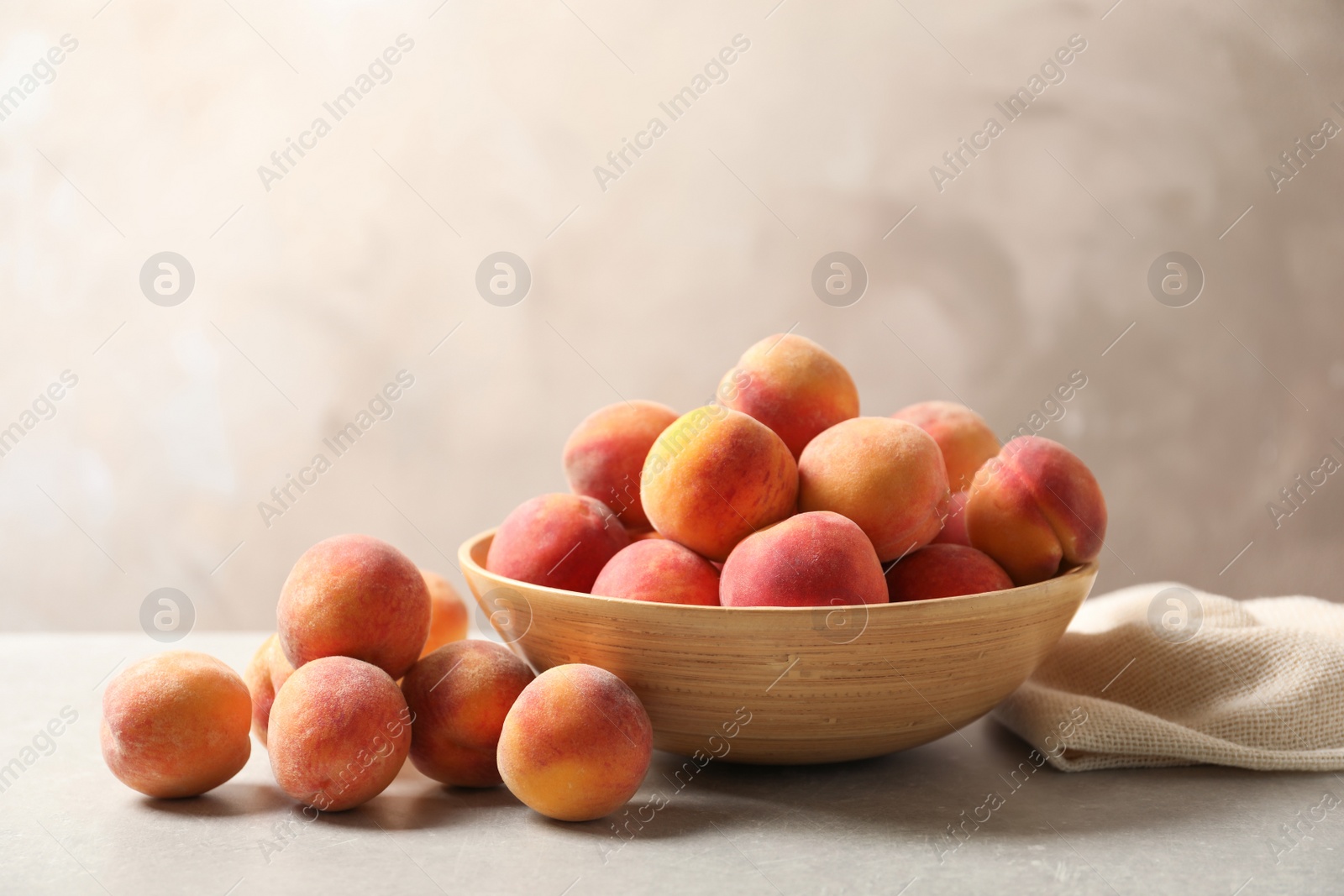 Photo of Delicious ripe peaches on table against grey background