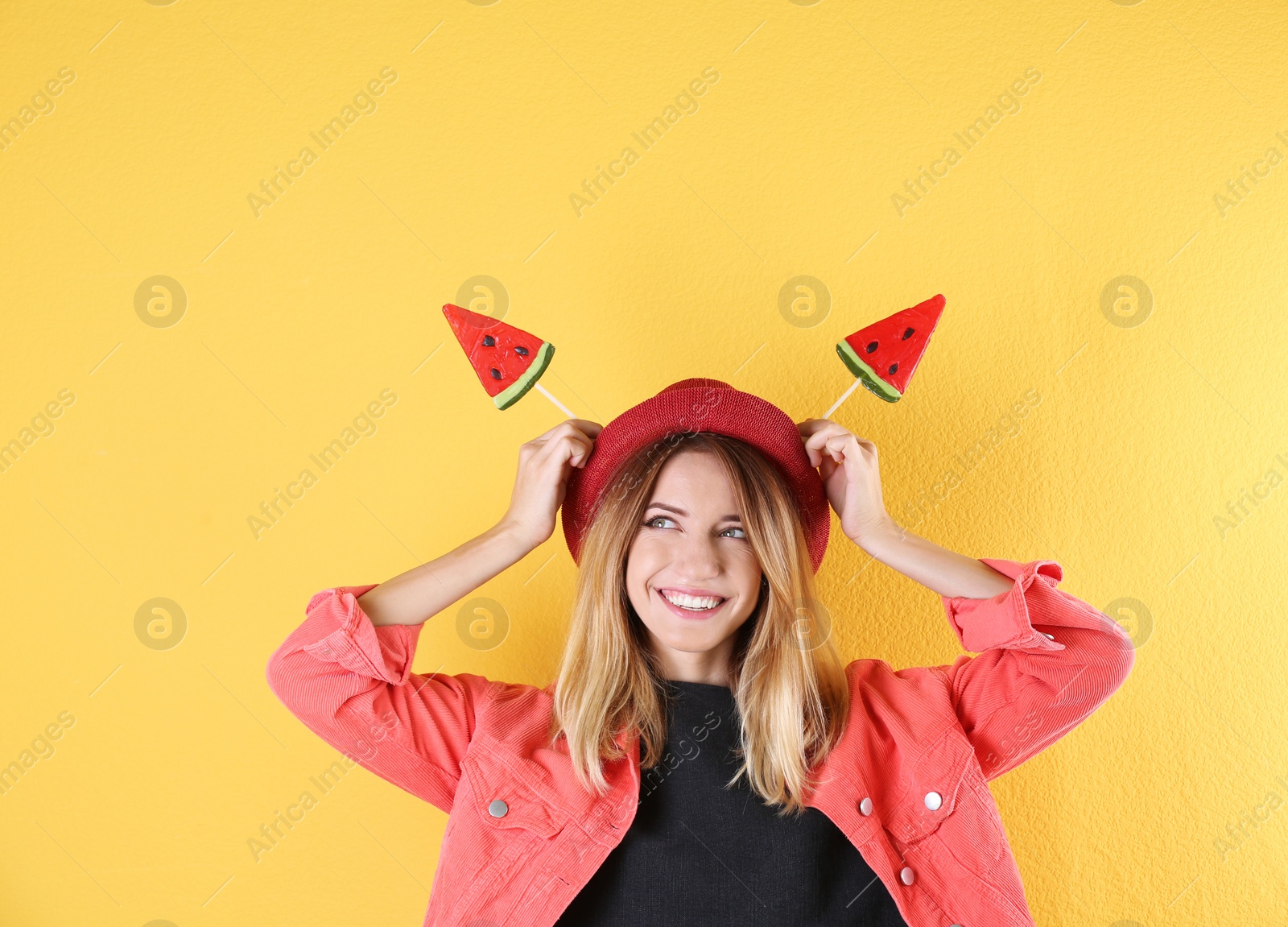 Photo of Young pretty woman with candies on colorful background