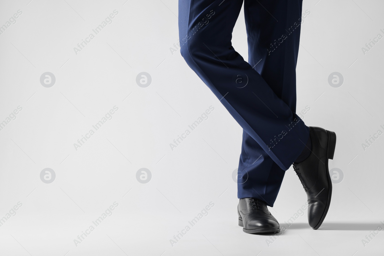 Photo of Businessman in leather shoes on white background, closeup