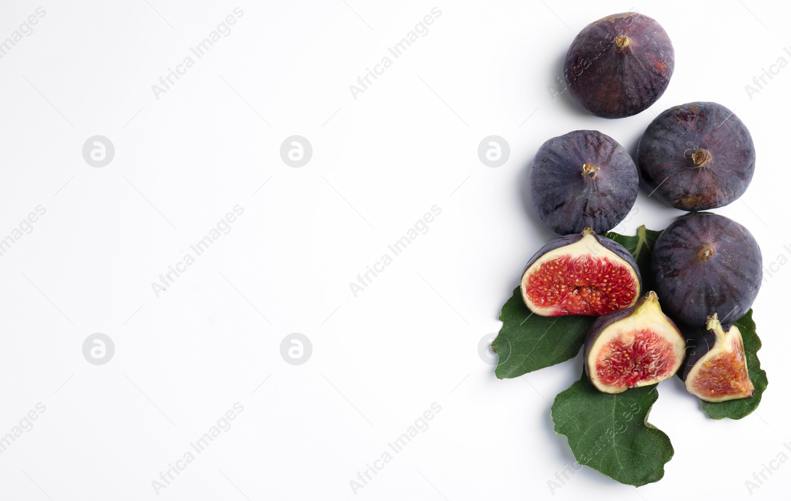 Photo of Delicious ripe figs with green leaf on white background, top view